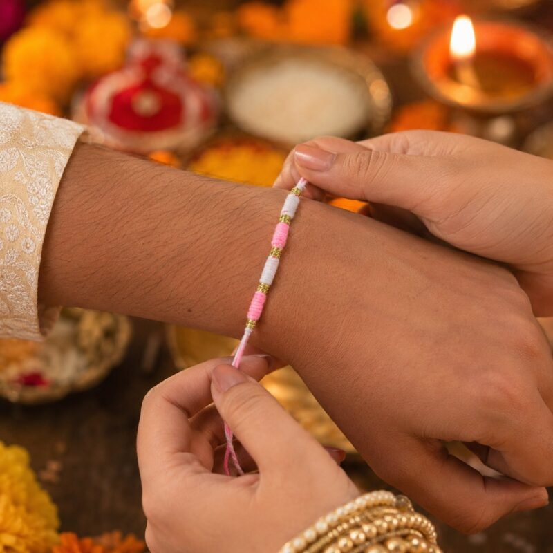 Pink & White Thread Rakhi � Elegant Traditional Beaded Design