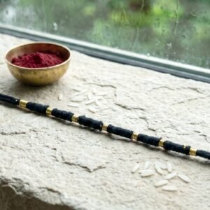 04_f444e113-16dc-4159-91c0-0854043ba2e7.jpg Rakhi � Handmade Black Thread with Gold Beads for Raksha Bandhan